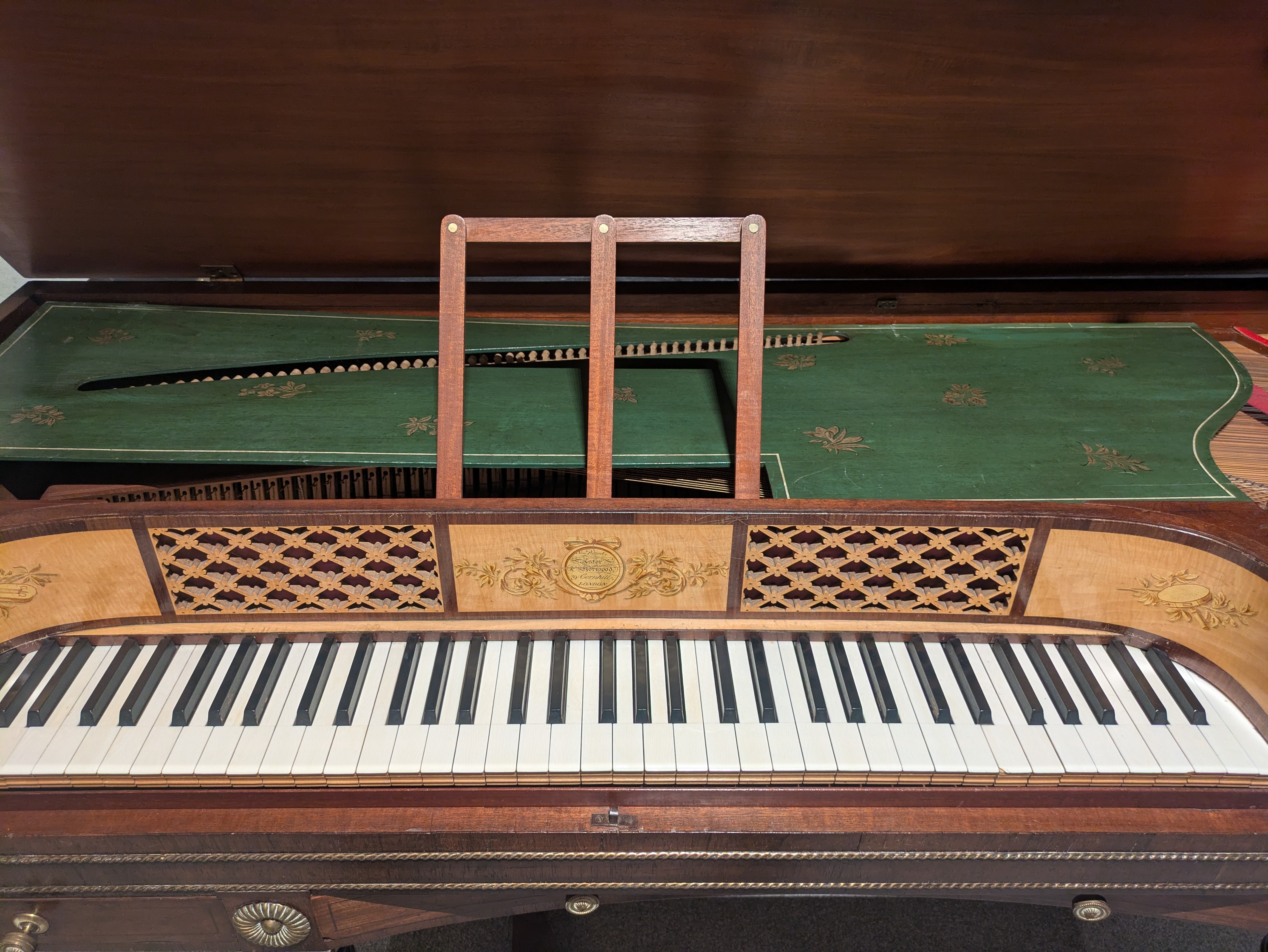 Front view of an early 19th-century square piano by Astor & Horwood, showing the curved frontboard and fretwork panels